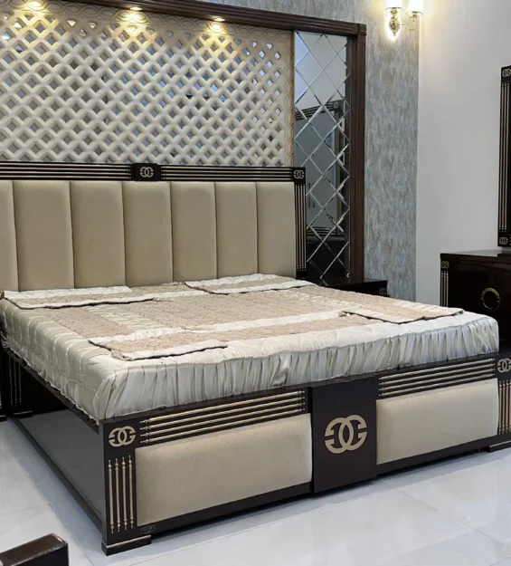 Modern bedroom showcasing a large upholstered bed, dark wood furniture, and mirrored wall accents.