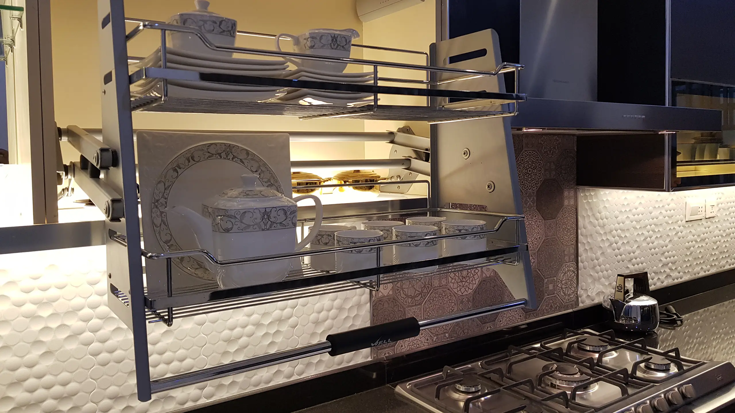 A modern pull-down dish rack providing smart kitchen storage for plates and bowls.